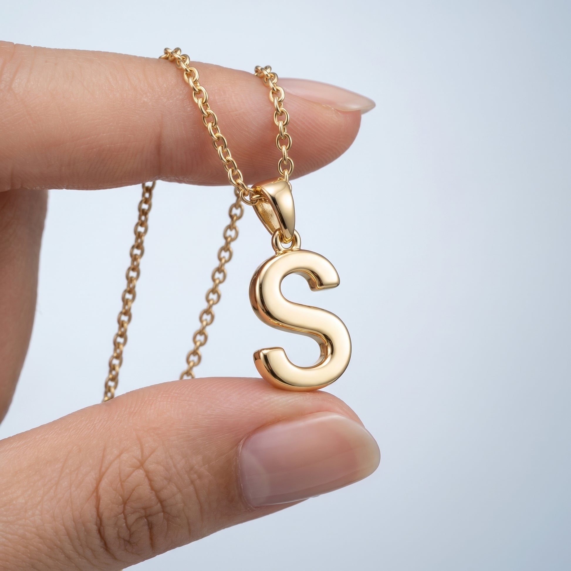Collana Iniziale Lettera Oro 18K - scala reale tra le dita di una mano - UpperEast Jewels