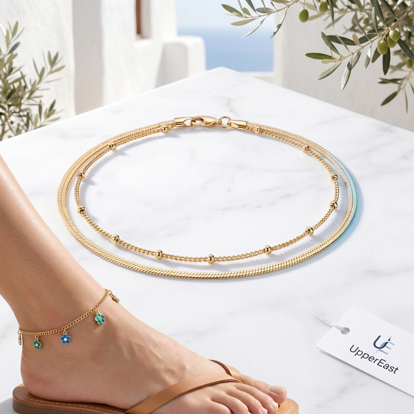 Cavigliera Layered Doppia Oro 18K - flat lay con pezzi coordinati - UpperEast Jewels